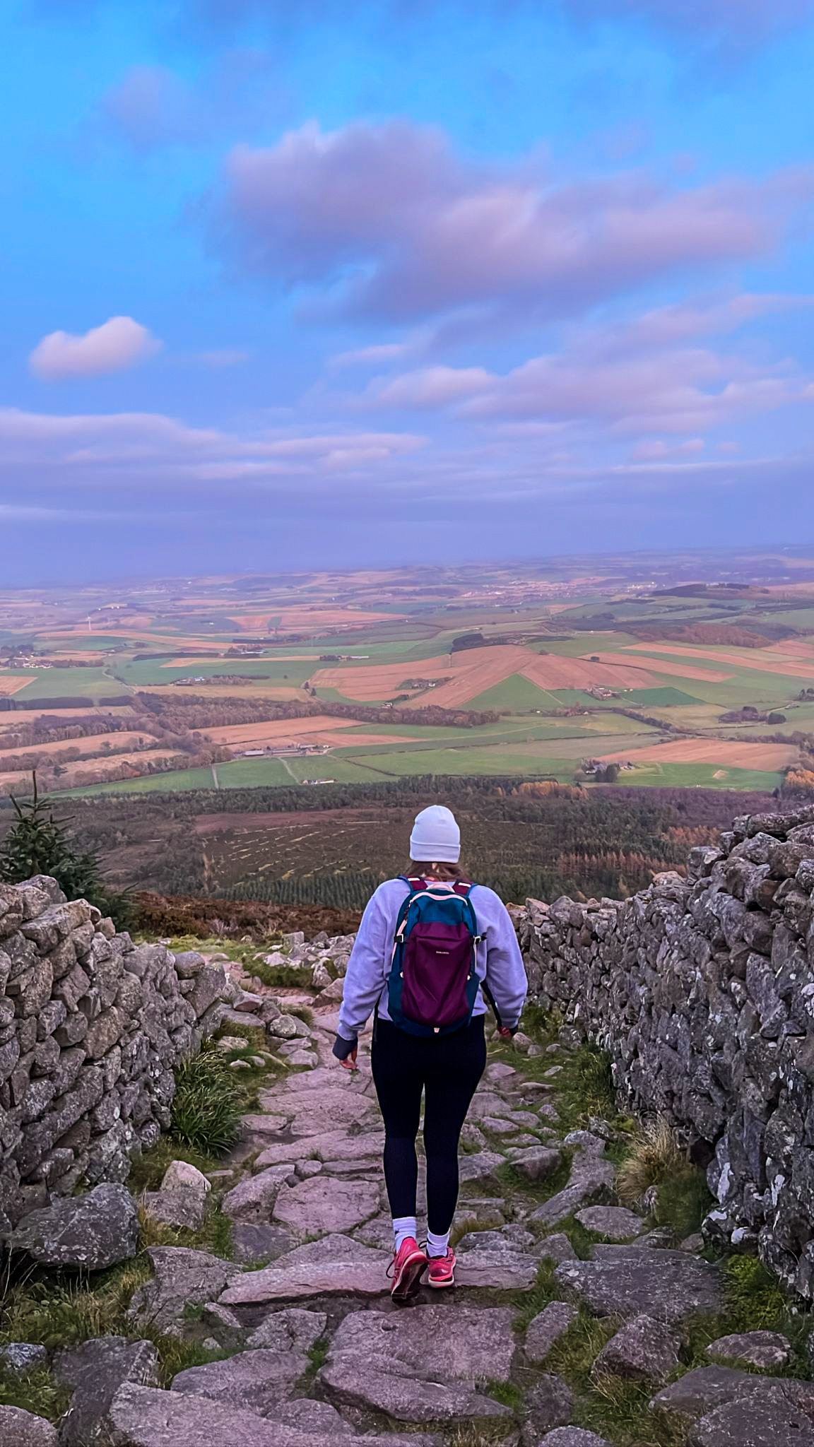 Jemma Reynolds hiking through a rural landscape